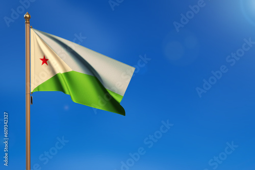 Djibouti. Flag blown by the wind with blue sky in the background.