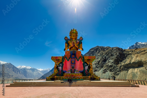 Big Sitting Buddha Statue at Diskit Monastery with Himalaya Range in the back - Nubra Valley, Ladakh, India
 photo