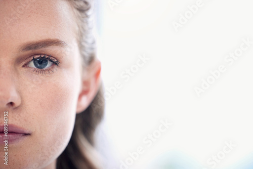 Woman, focus and half face with a healthy vision for awareness in australia for closeup. Serious, portrait and female person with eyes for concentration with eye test for wellness and seeing.