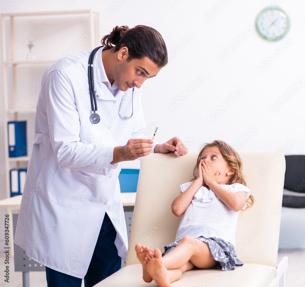 Young doctor pediatrician with small girl Young doctor pediatrician with small girl