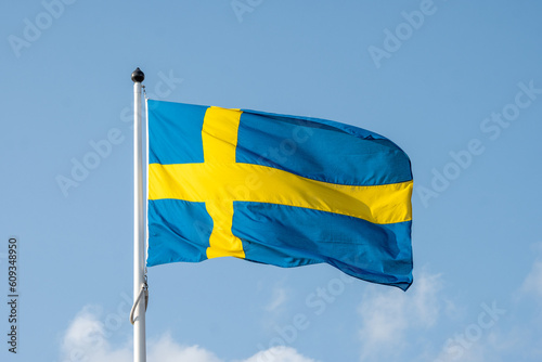Swedish Flag Day. Swedish Flag on Blue Sky Backdrop. The National Day of Sweden- Swedish Flag. Celebration of Swedish Flag.