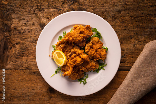 top view plate with fried chicken on wooden tabletop photo