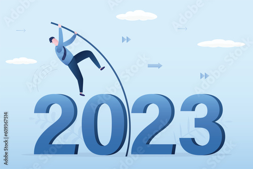 Confident businessman doing pole vaulting crossover crisis valley. Entrepreneur jumping over 2023 year with pole. Way forward, Successful overcoming obstacles, concept. Achieving success.