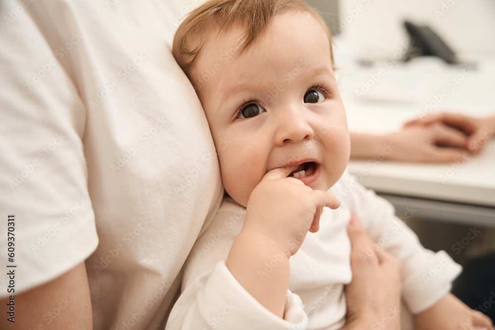Little child touching upper tooth with finger during medical consultation Little child touching upper tooth with finger during medical consultation