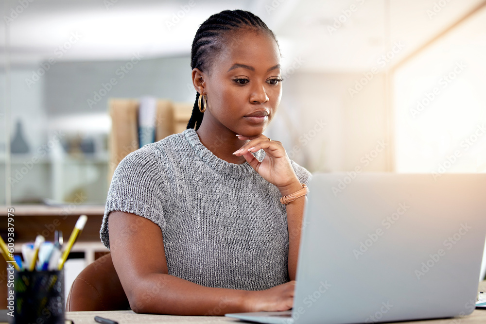Laptop, research and a business black woman thinking while working at her desk in her office with flare. Computer, planning and idea with a serious young female employee reading an email at work Laptop, research and a business black woman thinking while working at her desk in her office with flare. Computer, planning and idea with a serious young female employee reading an email at work