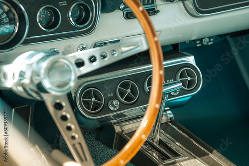 Steering wheel in a classic car, old automobile, vintage vehicle interior, wooden traditional cars dashboard dials, speed clocks speedo