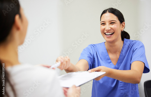 Documents, happy and a nurse helping a patient in the hospital during an appointment or checkup. Insurance form, smile and a medical assistant at a health clinic to help with check in or sign up photo