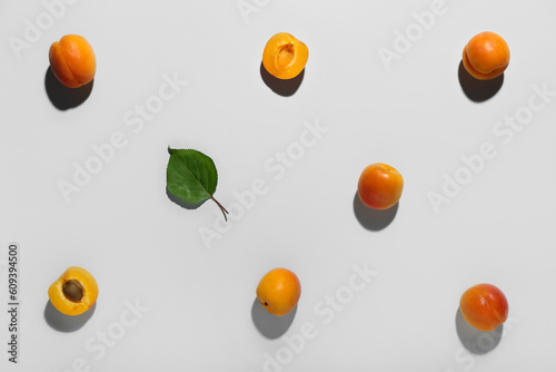 Fresh apricots with leaf on grey background