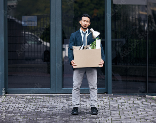 Depression, economy and box with a jobless business man walking outdoor in the city alone. Financial crisis, unemployment and fired with a young asian male employee looking sad in an urban town