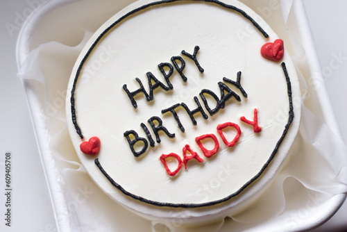 Happy birthday cake. Happy birthday cake background. Happy birthday cake on a white background. Birthday cake for dad with the words "Happy birthday daddy". White birthday cake. © Dubnytskaya Photo
