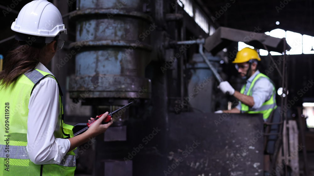Female engineer with safety vest and hard hat work check in manufacturing , Female Industrial Specialist Walk checking in a Metal Manufacture Female engineer with safety vest and hard hat work check in manufacturing , Female Industrial Specialist Walk checking in a Metal Manufacture