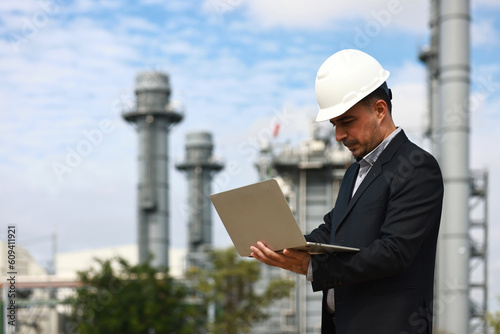Business man or management survey and audit at site line of factory, Cogeneration Power plant investment © naraichal