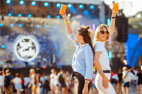 Happy girlfriends having fun at music festival. Summer holiday, vacation concept. Friendship and celebration concept.