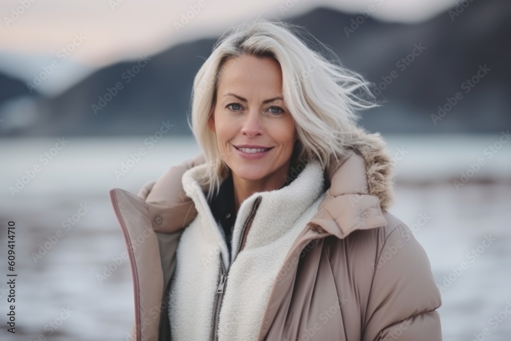 Portrait of a beautiful blonde woman in a sheepskin coat on the beach Portrait of a beautiful blonde woman in a sheepskin coat on the beach