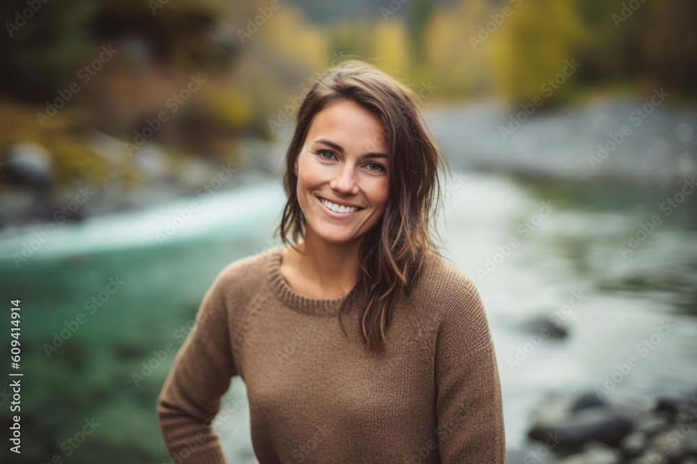Portrait of smiling woman standing by mountain river in autumnal forest Portrait of smiling woman standing by mountain river in autumnal forest
