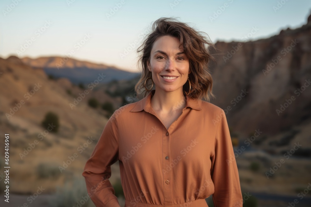 Portrait of a beautiful woman smiling at the camera in the desert Portrait of a beautiful woman smiling at the camera in the desert