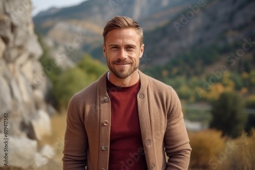 Portrait of a handsome man in the mountains. Men's beauty, fashion.