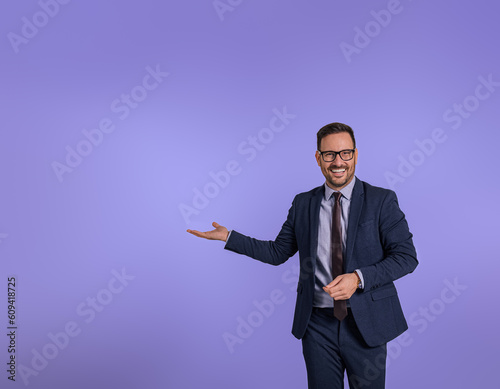 Foto Portrait of smiling handsome marketing manager showing copy space for business advertisement