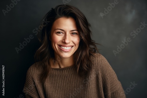 Portrait of a smiling woman looking at camera isolated over black background
