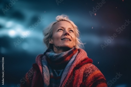 Medium shot portrait photography of a pleased woman in her 40s that is wearing a cozy sweater against a spectacular natural phenomenon like the northern lights background . Generative AI
