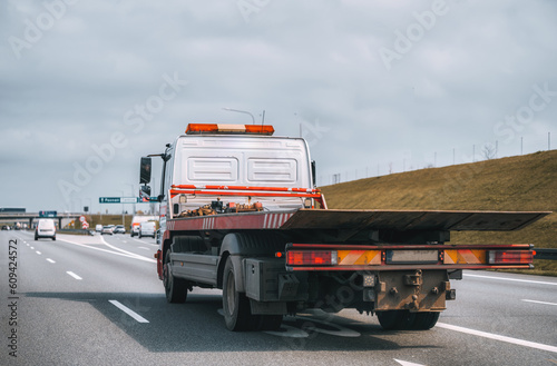 empty tow truck with drives down a highway