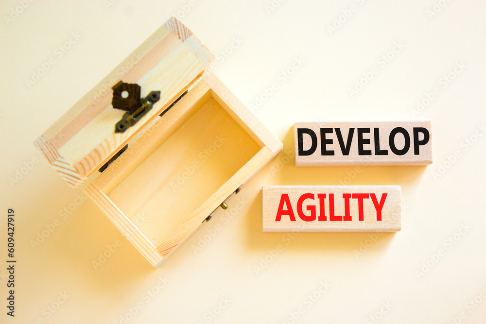 Develop agility symbol. Concept words Develop agility on wooden blocks on a beautiful white table white background. Empty wooden chest. Business, support and develop agility concept. Copy space.