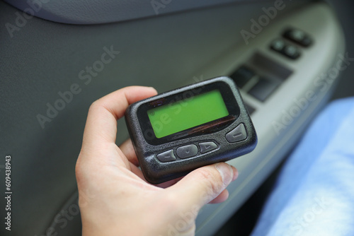 Beeper pager symbolizes communication, urgency, and efficiency in business and hospital settings. It represents the need for immediate response and coordination in professional environments photo