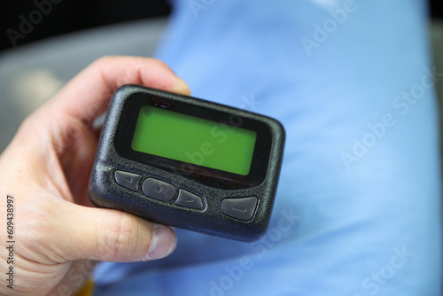 Beeper pager symbolizes communication, urgency, and efficiency in business and hospital settings. It represents the need for immediate response and coordination in professional environments
