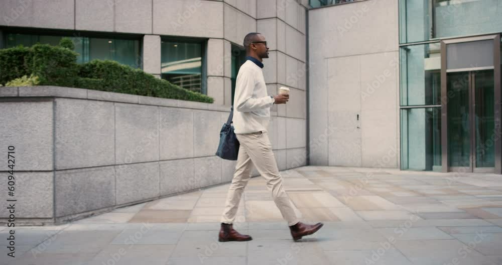 Coffee, walking and a black man in the city in the morning for a commute to work. Side, professional and an African employee on a walk on the sidewalk in a town for a job or career with a drink