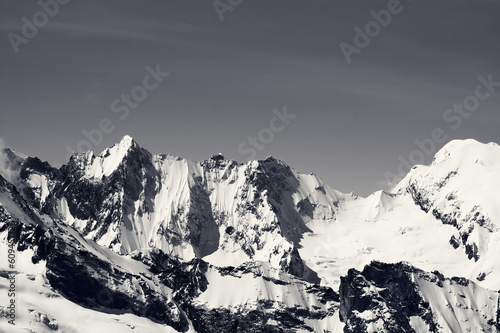 Black and white winter snowy mountains in cold sun day