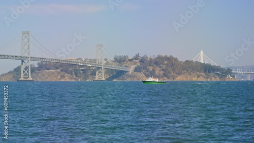 Ferry boat passes in front of Bay Bridge and Treasure Island, San Francisco Bay photo