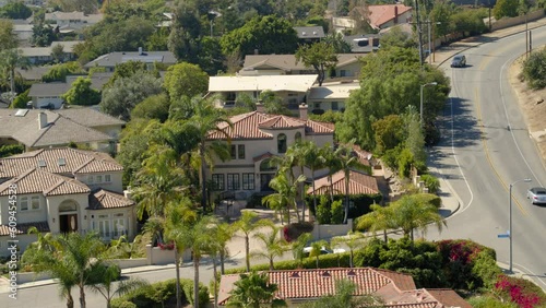 Aerial Panning Shot Of Houses By Road In Suburb Against Sky, Drone Flying Over Bungalows On Sunny Day - Ventura, California