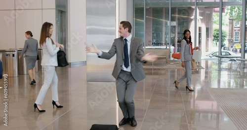 Business, dance and man in a lobby, celebration and happiness with joy, promotion and achievement. Male person, employee or consultant with success, career and dancing in a hallway, office and energy