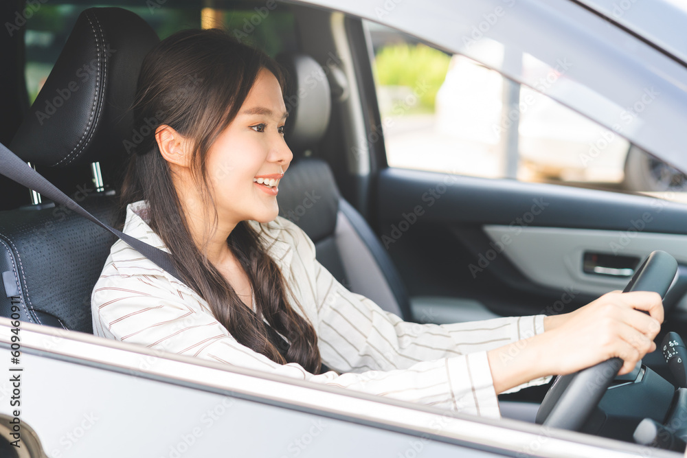 Transport concept, happy smile brunette hair asian young woman driving, getting new car, vehicle for travel, trip with face positive, female driver car with fasten safety seat belt before traveling.