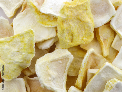 Freeze dried mango slices in a heap. Mango freeze dry delicious dessert tasty snack. lyophilized freeze dried fruit top view.