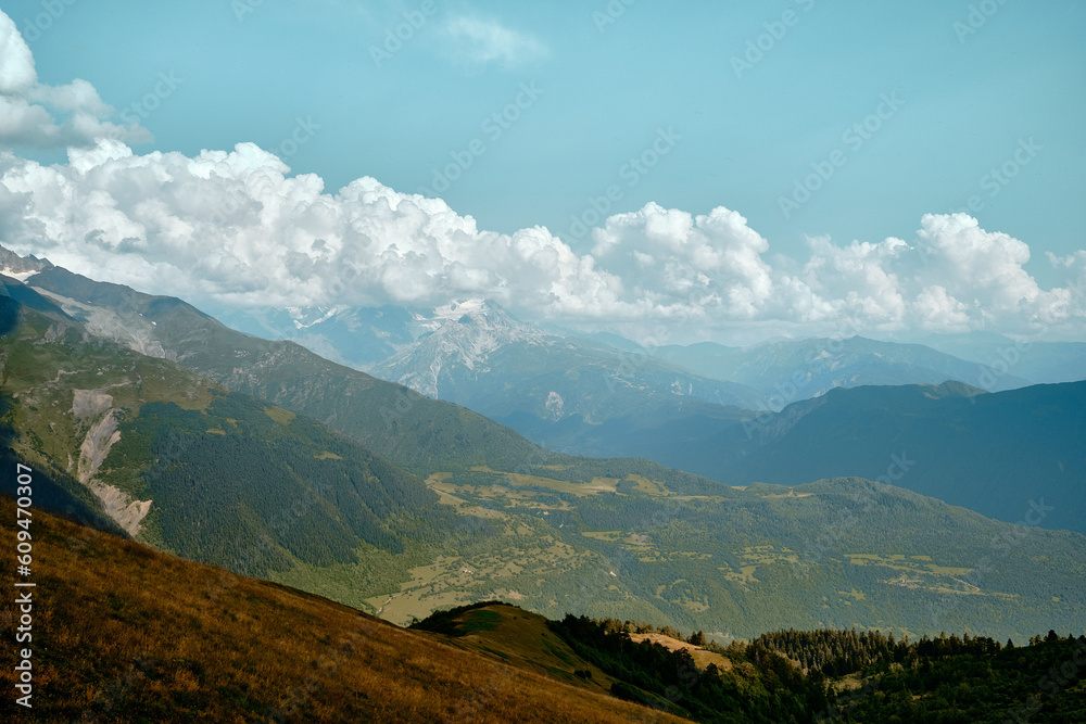 Mountain ranges on a sunny day at Georgia. Sky with clouds adn hills