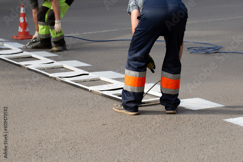 Installation of markings on the road. Repair of the road for cars in the city.