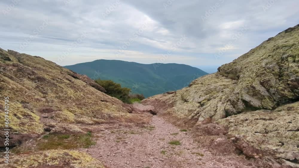 Panoramic view of the valley on top of the rocky ridge among the stones overlooking the beautiful valley. Outdoor and mountain hike background. Natural landscape in Bulgaria, Sliven Panoramic view of the valley on top of the rocky ridge among the stones overlooking the beautiful valley. Outdoor and mountain hike background. Natural landscape in Bulgaria, Sliven