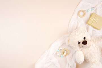 Baby shower 1st birthday christening gender neutral background framed border backdrop. Styled setting with teddy bear against a boho Scandi beige background. Negative copy space.