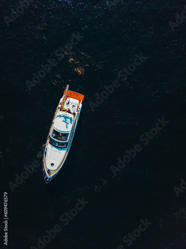 Aerial view on  luxury yacht docked in sea at sunset © Aleksandrs Muiznieks