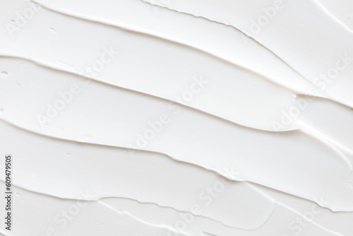 Swatch of white cream texture, cosmetics for face and body on a isolated light grey background. Smear. Real photo