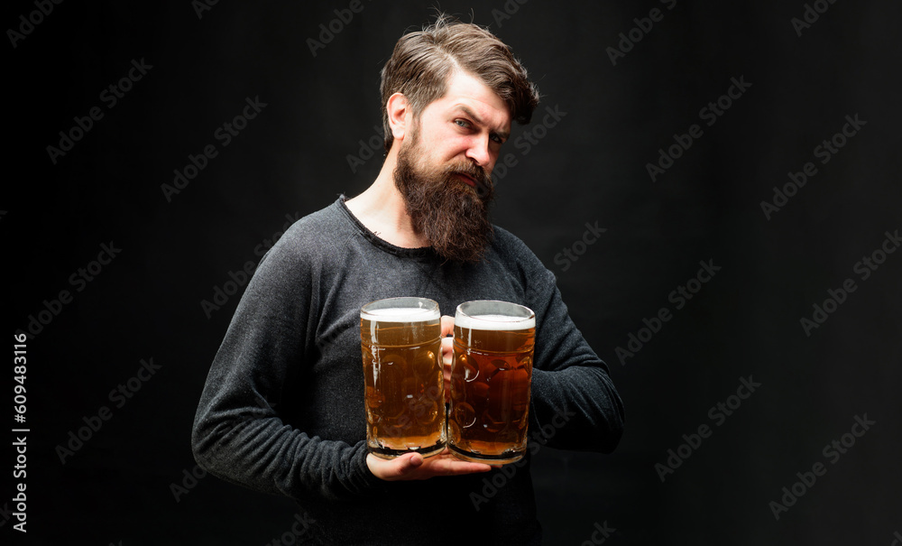 Bearded man with lager beer mugs at bar or pub. Stylish guy with craft beer. Bearded male tasting fresh brewed beer. Oktoberfest festival. Beer degustation. Drink, alcohol, leisure and people concept. Bearded man with lager beer mugs at bar or pub. Stylish guy with craft beer. Bearded male tasting fresh brewed beer. Oktoberfest festival. Beer degustation. Drink, alcohol, leisure and people concept.