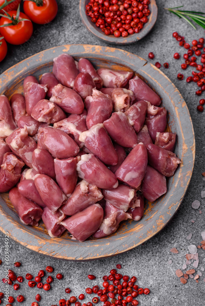Raw chicken or turkey hearts with salt, spices and herbs Raw chicken or turkey hearts with salt, spices and herbs