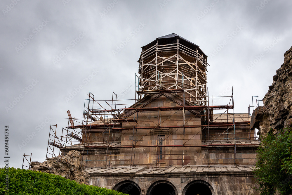 Zarzma Monastery of Transfiguration, medieval Orthodox Christian monastery located in the village of Zarzma in Samtskhe-Javakheti region, Georgia,building and belfry during renovation with scaffolding