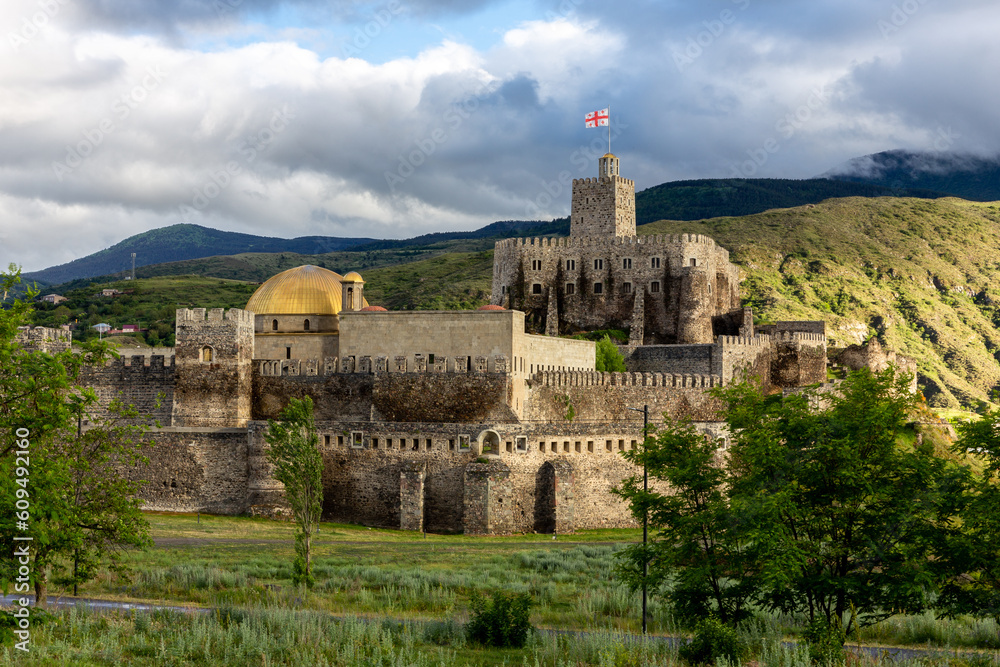 Akhaltsikhe (Rabati) Castle, medieval fortress in Akhaltsikhe, Georgia during sunset with cloudy sky in the background.