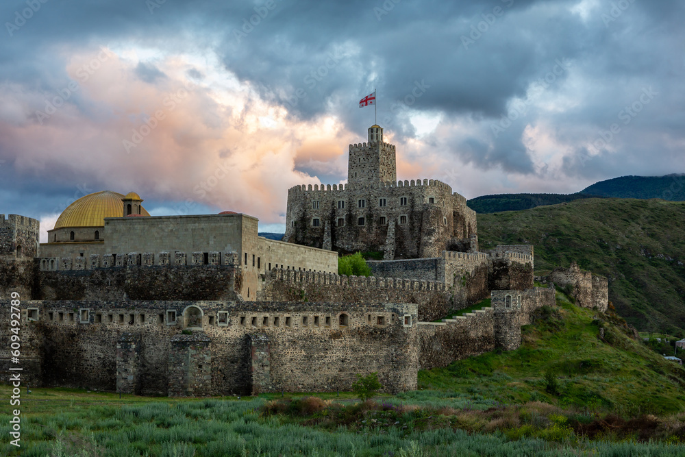 Akhaltsikhe (Rabati) Castle, medieval fortress in Akhaltsikhe, Georgia during sunset with colorful cloudy sky in the background.