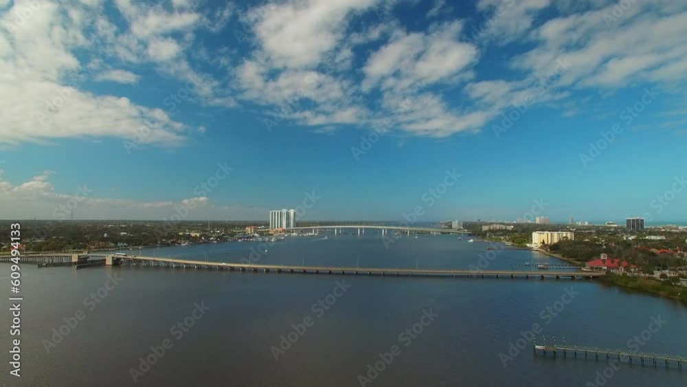 Aerial Shot Of Vehicles On Bridges Over Sea In City Against Sky, Drone Flying Forward Over Water - Daytona Beach, Florida Aerial Shot Of Vehicles On Bridges Over Sea In City Against Sky, Drone Flying Forward Over Water - Daytona Beach, Florida