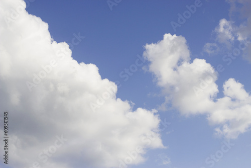 blue sky with diagonal fluffy clouds