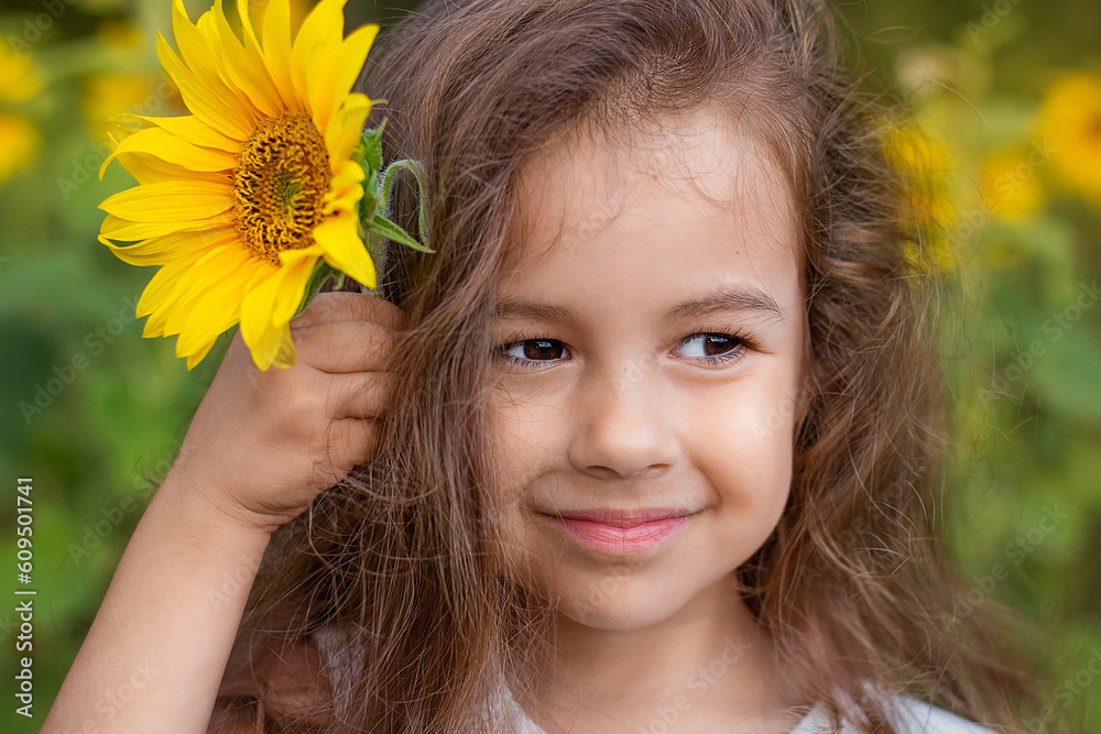 Cute little girl with sunflower flower. Close-up. Cute little girl with sunflower flower. Close-up.