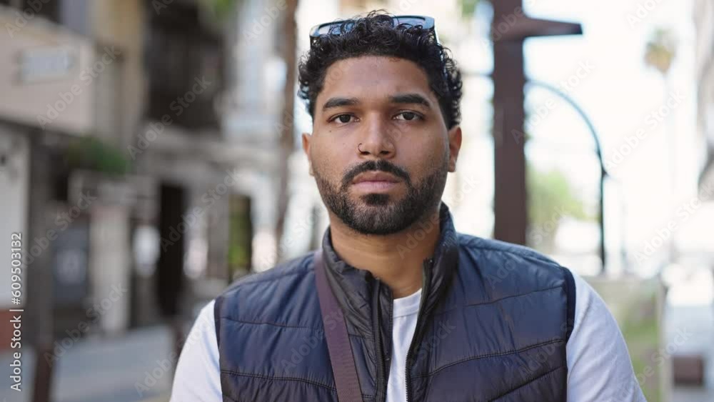 African american man standing with serious expression saying no with head at street African american man standing with serious expression saying no with head at street